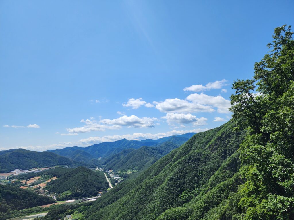 Breathtaking view of rolling mountain ranges under a clear sky in the Taebaek region.