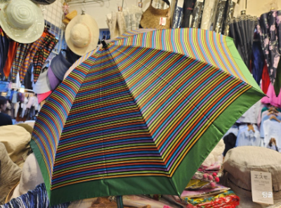 Vintage retro striped Japanese UV sun parasol umbrella opened at Orea in Namdaemun Market